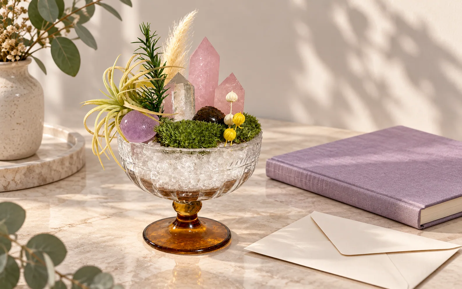 A crystal garden beside a closed lavender notebook and sealed envelope.