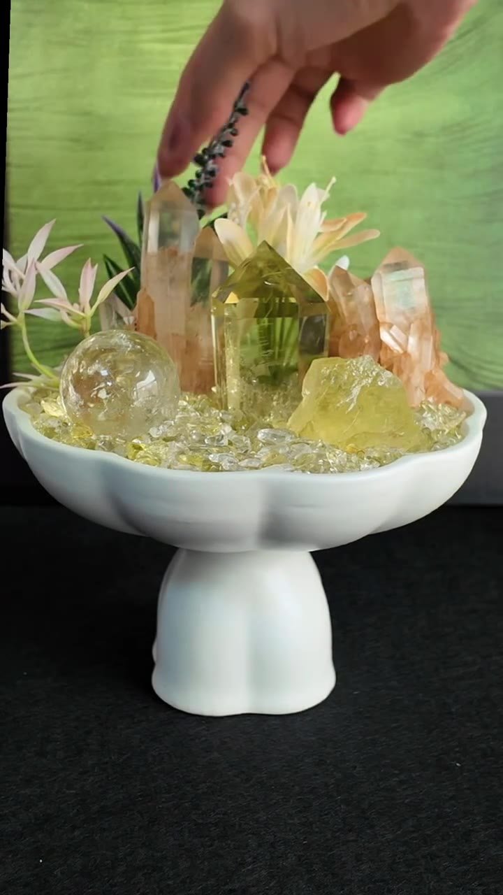 A golden crystal arrangement in a white pedestal bowl